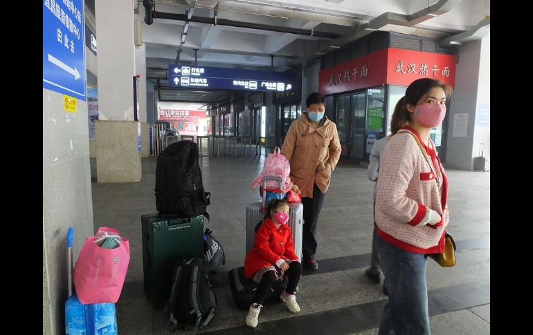 Una familia espera su tren en una estación de tren en Yichang, provincia de Hubei. EFE/L. Junfeng