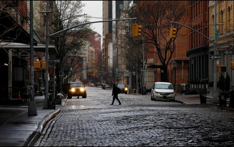 Una persona camina por las calle semivacías del barrio neoyorquino de Tribeca. EFE/P. Foley