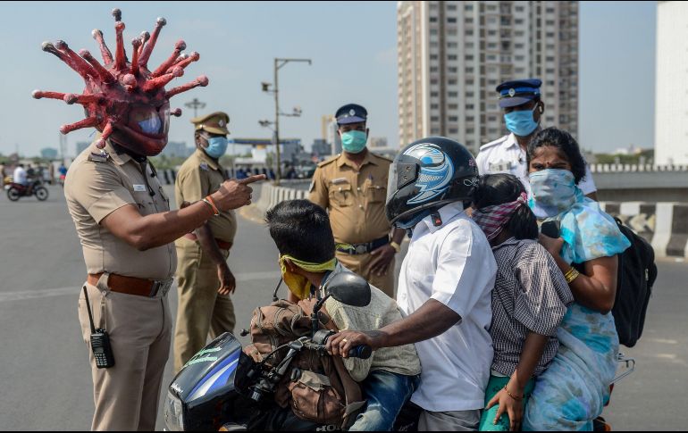 En la ciudad de Chennai, en India, un policía realiza su trabajo con un casco con forma de coronavirus COVID-19. AFP/A. Sankar