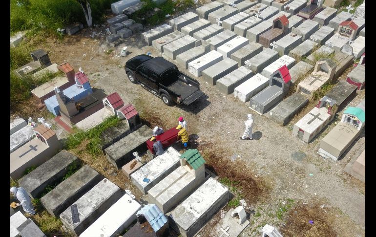 En Ecuador se reportan 355 fallecidos por coronavirus, y se sospecha de otros 424 probables. Trabajadores en un entierro el domingo en el cementerio María Canals, a las afueras de Guayaquil. AFP