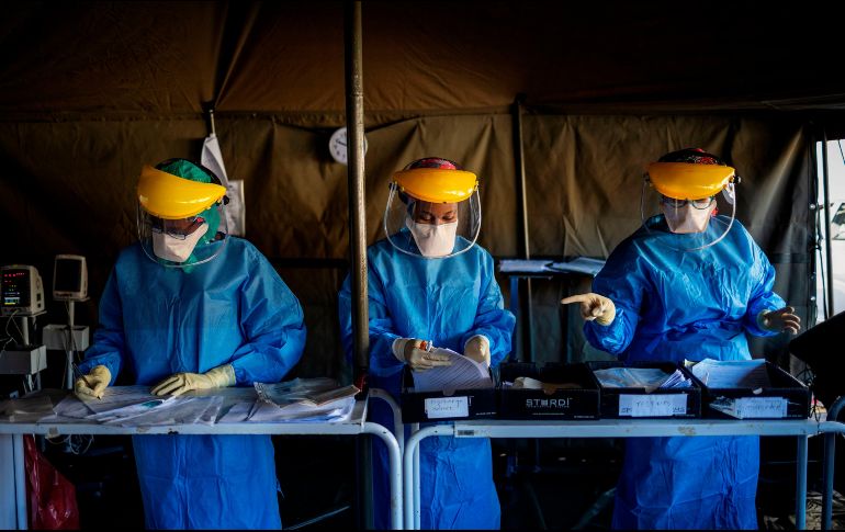Trabajadores llenan formularios antes de realizar pruebas de  COVID-19 a personal de salud en un hospital en Johannesburgo, Sudáfrica. AFP/M. Spatari