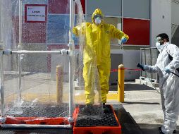 Trabajadores de la salud demuestran el proceso de sanitización en el recién inaugurado hospital móvil para pacientes de COVID-19 en Ciudad Juárez. AP/H. Martínez
