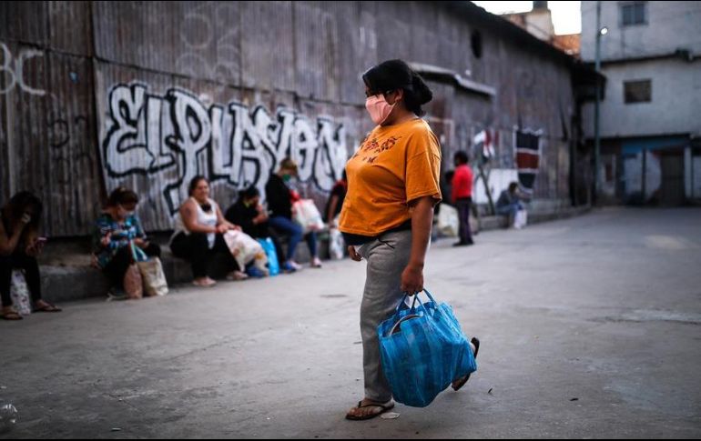 Personas necesitadas acuden a un comedor comunitario este miércoles en un barrio humilde de Buenos Aires. EFE/J. Roncoroni