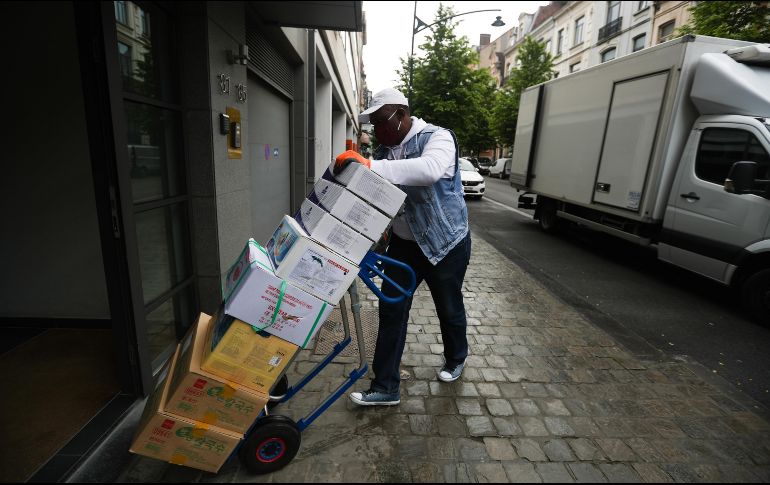 Portero entrega productos en un edificio de Bruselas. XINHUA/Z. Huansong