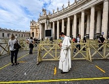 Personas hacen fila con medidas de distanciamiento para ingresar a la basílica. AFP/V. Pinto