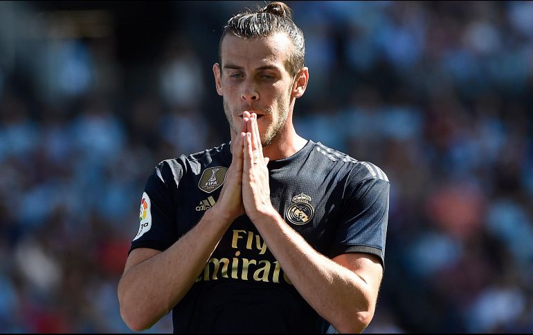 El galés señala que el golf le ayuda a concentrarse y sentirse mejor con el futbol. AFP / ARCHIVO