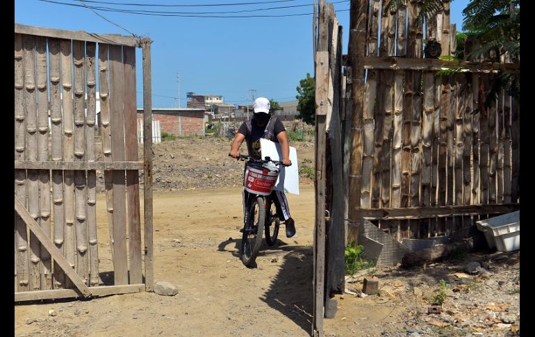 Con el alumno a dos metros de distancia, Espinoza coloca la pizarra donde puede y repite la clase que horas antes había impartido por Zoom. EFE/M. Pin