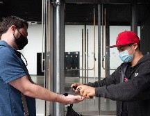 Un trabajador de un supermercado aplica desinfectante a un cliente hoy en la ciudad de Nueva York. El estado del mismo nombre, que fue epicentro de la pandemia, registra ahora un descenso de los casos. AP/M. Lennihan