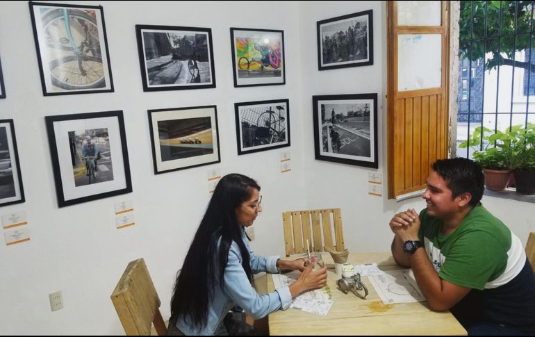 NUEVO ESPACIO. La gente disfruta de la cafetería El Santuario de la Bicicleta, rodeados de distintas obras fotográficas. CORTESÍA