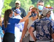 Personas entran al parque de diversiones Epcot de Walt Disney en Lake Buena Vista, Florida, en el día de su reapertura oficial. Los destinos recreativos se debaten en torno a cómo y cuándo reanudar las actividades. AP/Orlando Sentinel /J. Burbank