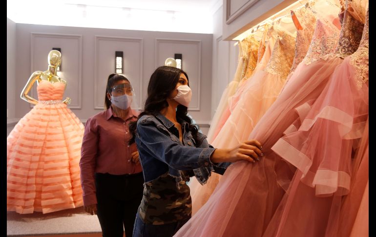 Una mujer observa vestidos de novia. Las tiendas han vuelto a abrir luego de que adaptaron protocolos sanitarios. EFE/F. Guasco
