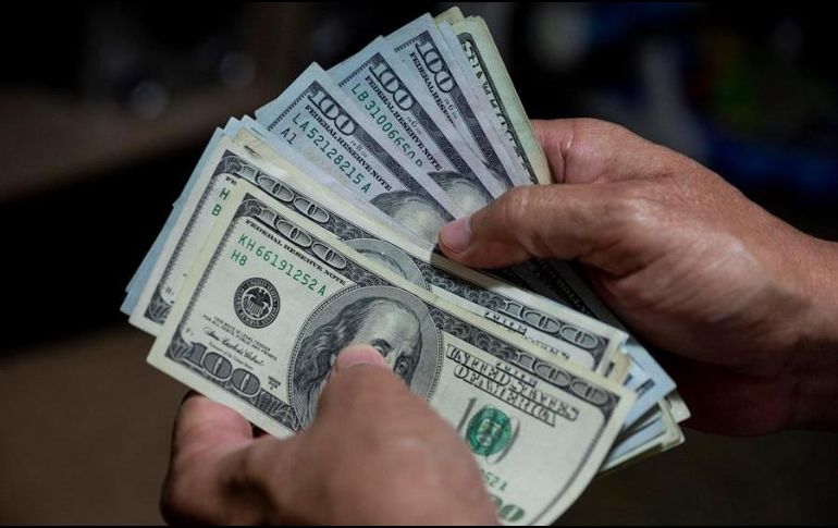Economistas aseguran que, si no fuera por los ingresos que recibe el país por concepto de remesas, el dólar podría estarse intercambiando en 24 pesos. EFE/R. Peña