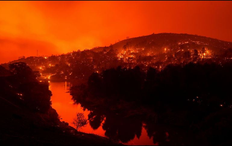 La televisora local mostró imágenes de viviendas en llamas y una lluvia de cenizas en una zona rural cerca de la Carretera Interestatal 80, mientras el incendio parecía acercarse a la zona poblada. AP / N. Berger