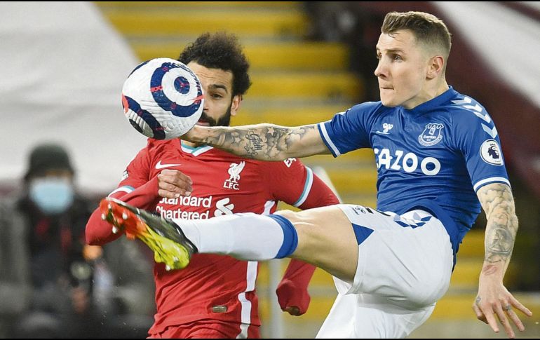 EN UN TOBOGÁN. Lucas Digne, de Everton, le gana el balón a Mohamed Salah, de los Reds. AP