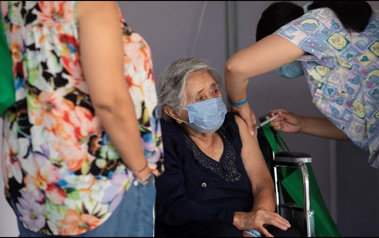 Una enfermera le administra una vacuna contra el nuevo coronavirus a una anciana en un centro de vacunación masivo localizado en la comuna de La Florida, en Santiago. EFE/A. Valdés