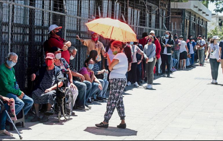 PARQUE AGUA AZUL. Miles de personas se formaron ayer en el segundo día de vacunación en Guadalajara. En la imagen se observa a familiares e incluso a adultos mayores en sillas de ruedas, con bastones y bajo los rayos del Sol. EL INFORMADOR • G. GALLO