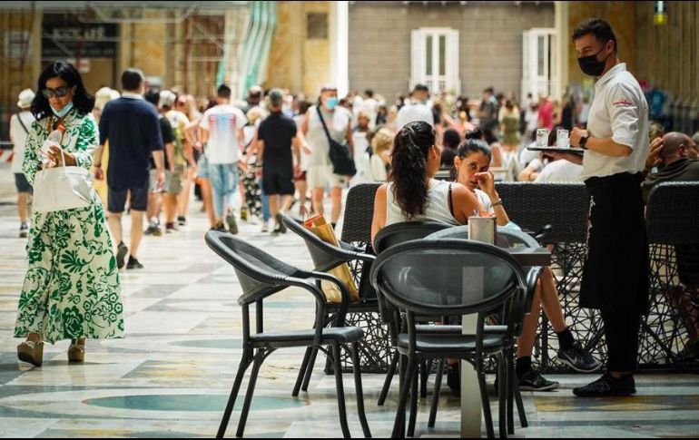 Un camarero atiende a los clientes en la terraza de un restaurante en Nápoles, Italia. EFE/C. Abbate