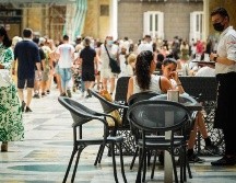 Un camarero atiende a los clientes en la terraza de un restaurante en Nápoles, Italia. EFE/C. Abbate