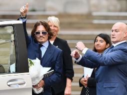 US actor Johnny Depp gestures as he leaves court after the sixth day