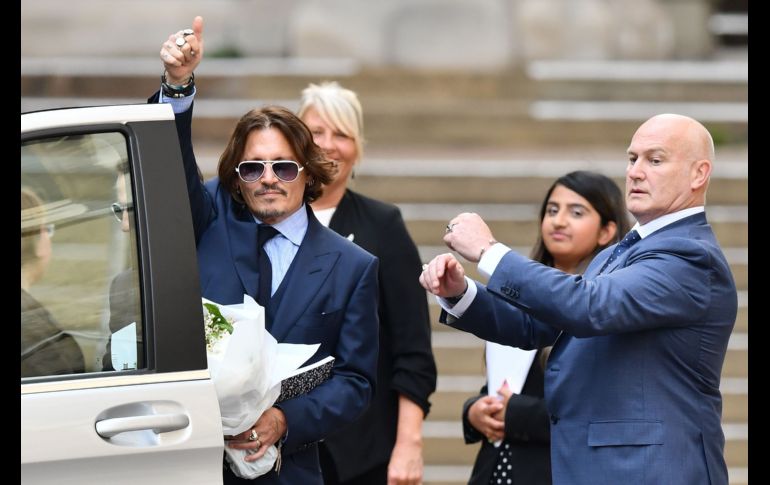 US actor Johnny Depp gestures as he leaves court after the sixth day