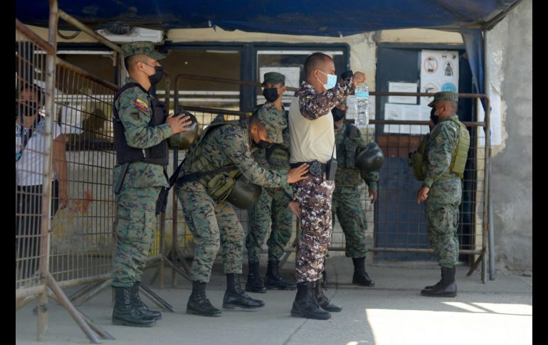 Soldados catean hoy a un policía en el ingreso a la cárcel de Guayaquil, donde ayer se registró la disputa entre reos. AFP/F. Méndez