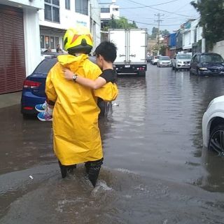 Por inundación en Zapopan, rescatan a una mujer y dos niños de un auto