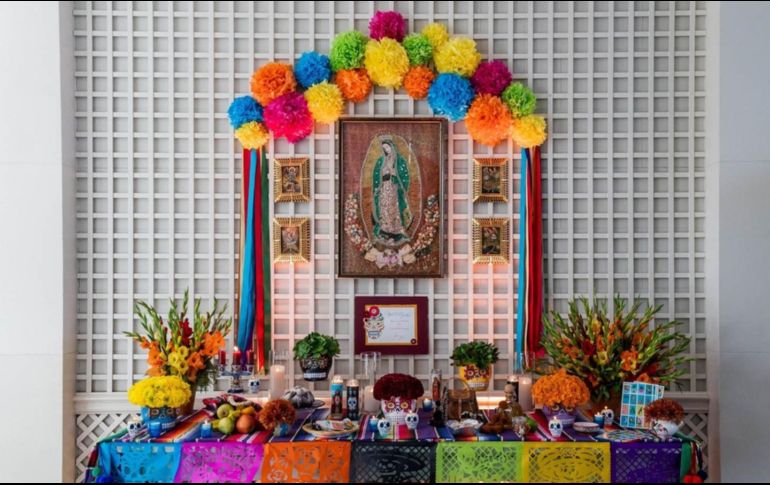 Frutas, flores de cempasúchil y de otros tipos, calaveras, velas, pan de muerto, papel picado y hasta un juego de lotería, son algunos de los elementos incluidos en el altar, cubierto por un sarape mexicano. TWITTER / @LaCasaBlanca