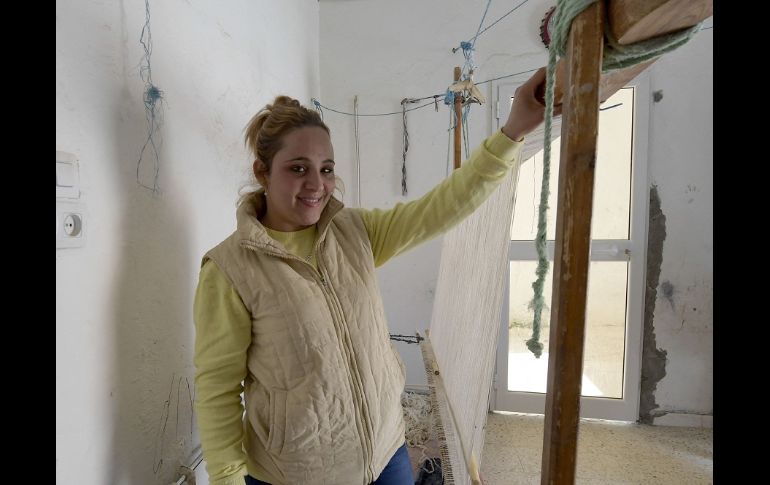 Viejos gorros de lana o calcetines sirven como materias primas para un bello tapiz negro, beige y con tonos dorados. AFP/F. Belaid
