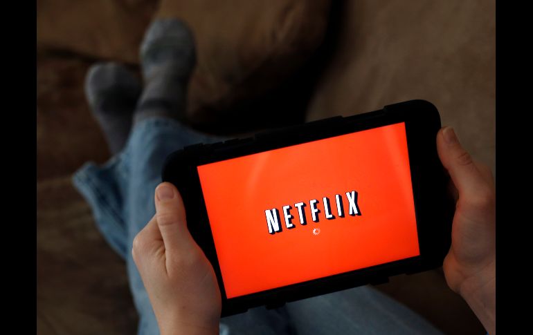 FILE - In this Friday, Jan. 17, 2014, file photo, a person displays Netflix on a tablet in North Andover, Mass. Netflix reports earnings Monday, April 17, 2017. (AP Photo/Elise Amendola, File) Earns Netflix-JAN. 17, 2014, FILE PHOTO