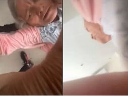 En el video se observa a dos jóvenes que intentan poner de pie a su abuela. ESPECIAL/CAPTURA DE VIDEO