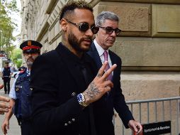Con traje negro, gafas de sol y una sonrisa, Neymar llegó a la Audiencia de Barcelona acompañado de sus padres. AFP / P. Barrena