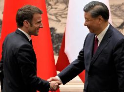 El presidente francés, Emmanuel Macron, le da la mano al presidente chino, Xi Jinping, luego de reunirse con la prensa en el Gran Salón del Pueblo en Beijing. EFE