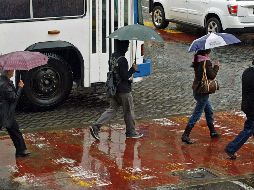 El pronóstico es de cielo medio nublado a nublado durante el día, con chubascos, descargas eléctricas y posible caída de granizo en Michoacán, lluvias aisladas en Jalisco y Colima, y sin lluvia en Nayarit. EL INFORMADOR / ARCHIVO