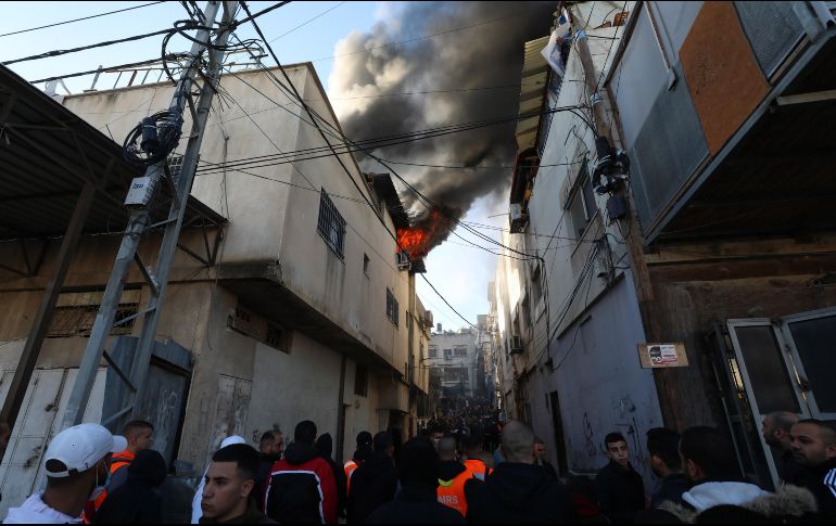 Humo y fuego salen de una casa destruida por el ejército israelí tras una redada en el campo de refugiados de Al Nur Shams, cerca de la ciudad cisjordana de Tulkarem. EFE/A. Badarneh