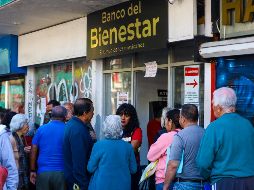 Algunos adultos mayores esperan desde madrugada para ser los primeros en cobrar y al caer el día la espera permanece. EL INFORMADOR/A. NAVARRO