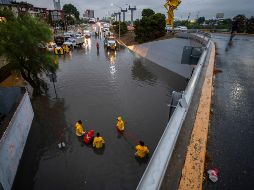 Integrantes de Protección Civil trabajan en un desnivel inundado debido a las fuertes lluvias provocadas por la próxima llegada de la tormenta tropical Alberto, este miércoles en Monterrey.  EFE/M. Sierra.
