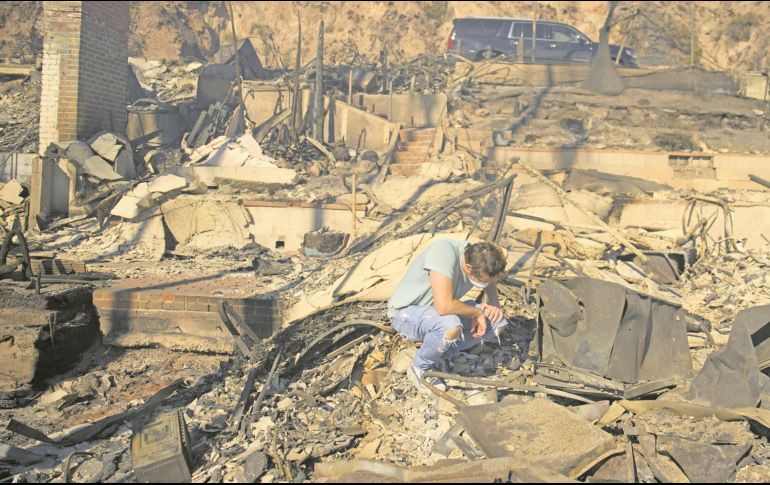 Habitantes de las zonas siniestradas regresan a sus hogares, en cenizas. AP