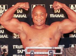 El boxeador de peso pesado George Foreman flexiona sus músculos después de pesar 260 libras para su próxima pelea contra Shannon Briggs en el Trump Taj Mahal Casino Resort en Atlantic City, Nueva Jersey, el jueves 20 de noviembre de 1997.  AP/ ARCHIVO.