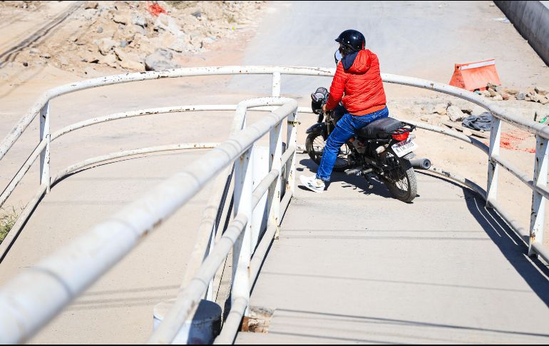Motociclistas suben a los puentes peatonales en Carretera a Chapala para evitar el tráfico ocasionado por las obras. EL INFORMADOR/J.ACOSTA