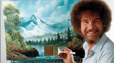 Ross, un pilar de la televisión pública durante las décadas de 1980 y 1990, era conocido por su frondoso cabello y su cálida personalidad Bob Ross posa para una fotografía frente a una de sus obras. Bob Ross Inc./AP