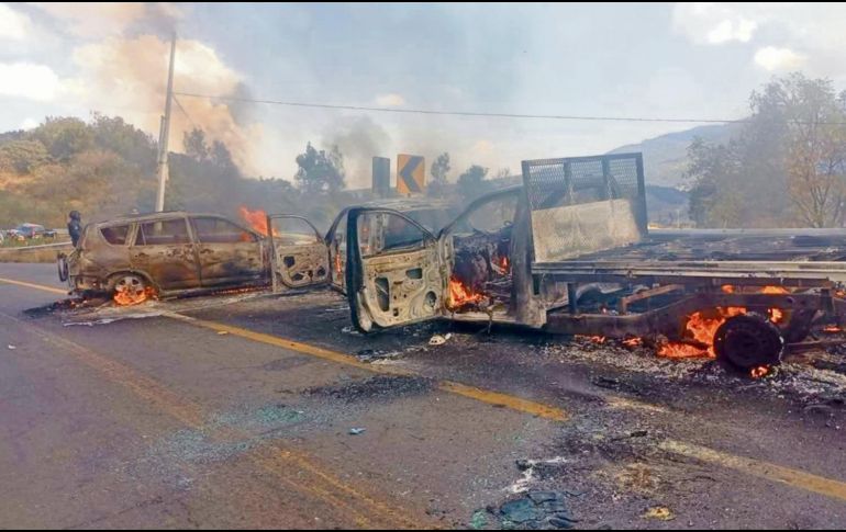 Elementos de seguridad retiran vehículos incendiados tras los bloqueos provocados por presuntos integrantes del cártel en 16 municipios de Michoacán. CORTESÍA