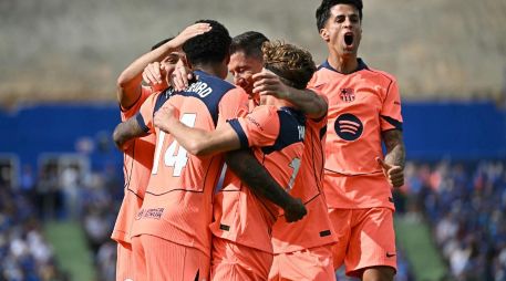 El Barça se afianza en el liderato del campeonato, ahora con una amplia ventaja de once puntos sobre el Real Madrid, a falta de cinco jornadas y quince puntos por disputarse. AFP / J. Soriano