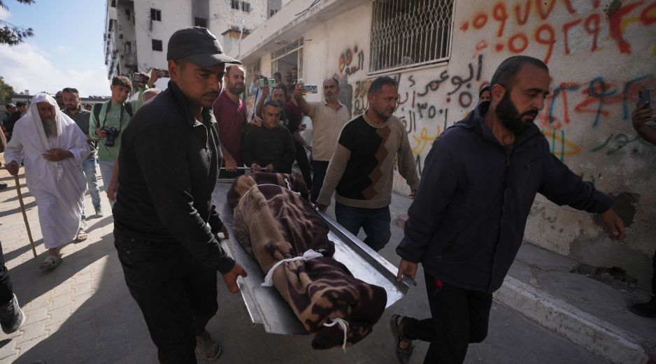 Palestinos cargan con el cuerpo de una persona fallecida en los ataques aéreos israelíes contra Izz al-Din al-Haddad, líder de las Brigadas Qassam de Hamás. AP/J. Alshrafi