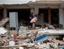 Una persona busca pertenencias en medio de los escombros de un edificio este domingo, en La Guaira, Venezuela. EFE/ R. Peña