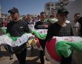 Dolientes cargan los cuerpos, cubiertos con banderas, de palestinos muertos en ataques israelíes durante la guerra contra Hamás, cuyos restos fueron recuperados recientemente de entre los escombros, en Ciudad de Gaza, el jueves 20 de agosto de 2026. Foto AP/J. Alshrafi