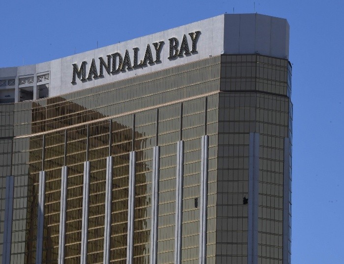 TOPSHOTS - TOPSHOT - The damaged windows on the 32nd floor room that was used by the shooter in the Mandalay Hotel after a gunman killed at least 58 people and wounded more than 500 others when he opened fire on a country music concert in Las Vegas, Nevada on October 2, 2017.  Police said the gunman, a 64-year-old local resident named as Stephen Paddock, had been killed after a SWAT team responded to reports of multiple gunfire from the 32nd floor of the Mandalay Bay, a hotel-casino next to the concert venue. / AFP / Mark RALSTON TOPSHOTS-TOPSHOT-US-CRIME-SHOOTING