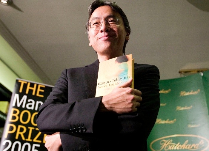 (FILES) This file photo taken on October 10 - (FILES) This file photo taken on October 10, 2005 shows British author Kazuo Ishiguro posing with his book at Hatchards book store in London, prior to the announcement of the winner of the The Man Booker Prize for Fiction. British author Kazuo Ishiguro wins the Nobel Literature Prize, the Swedish Academy in Stockholm announced on October 5, 2017 / AFP / LEON NEAL FILES-BRITAIN-LITERATURE-NOBEL-PRIZE