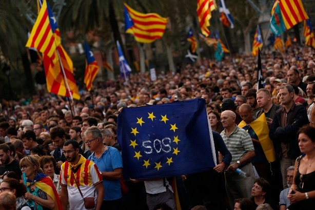 Pro-independence supporters hold a European Union flag during a rally - Pro-independence supporters hold a European Union flag during a rally in Barcelona, Spain, Tuesday, Oct. 10, 2017. Catalan President Carles Puigdemont said during his speech in the parliament that the region remained committed to independence but said it should follow dialogue with the government in Madrid. ((AP Photo/Francisco Seco) Spain Catalonia