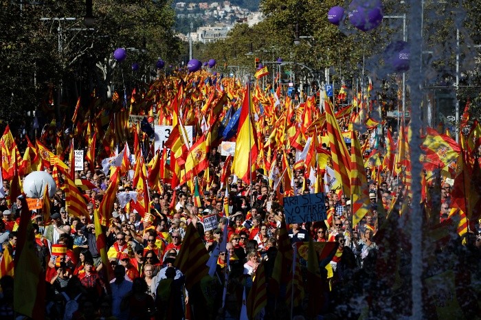 Nationalist activists march with Catalan - Nationalist activists march with Catalan, Spanish and European Union flags during a mass rally against Catalonia's declaration of independence, in Barcelona, Spain, Sunday, Oct. 29, 2017. Thousands of opponents of independence for Catalonia held the rally on one of the city's main avenues after one of the country's most tumultuous days in decades. (AP Photo/Emilio Morenatti) Spain Catalonia