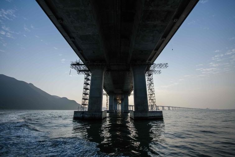 In this picture taken on December 11 - In this picture taken on December 11, 2017, a general view shows a section of the Hong Kong-Zhuhai-Macau Bridge (HKZMB) in Hong Kong. Billed as the world's longest sea bridge connecting Hong Kong, Macau and mainland China, it has been touted by supporters as an engineering wonder. But critics say the multi-billion dollar infrastructure mega-project is politically driven and a costly white elephant.  - TO GO WITH AFP STORY HONG KONG-MACAU-CHINA-POLITICS-ECONOMICS-BRIDGE,FOCUS BY ELAINE YU AND LAURA MANNERING / AFP / Anthony WALLACE / TO GO WITH AFP STORY HONG KONG-MACAU-CHINA-POLITICS-ECONOMICS-BRIDGE,FOCUS BY ELAINE YU AND LAURA MANNERING HONG KONG-MACAU-CHINA-POLITICS-ECONOMICS-BRIDGE - TO GO WITH AFP STORY HONG KONG-MACAU-CHINA-POLITICS-ECONOMICS-BRIDGE,FOCUS BY ELAINE YU AND LAURA MANNERING / TO GO WITH AFP STORY HONG KONG-MACAU-CHINA-POLITICS-ECONOMICS-BRIDGE,FOCUS BY ELAINE YU AND LAURA MANNERING